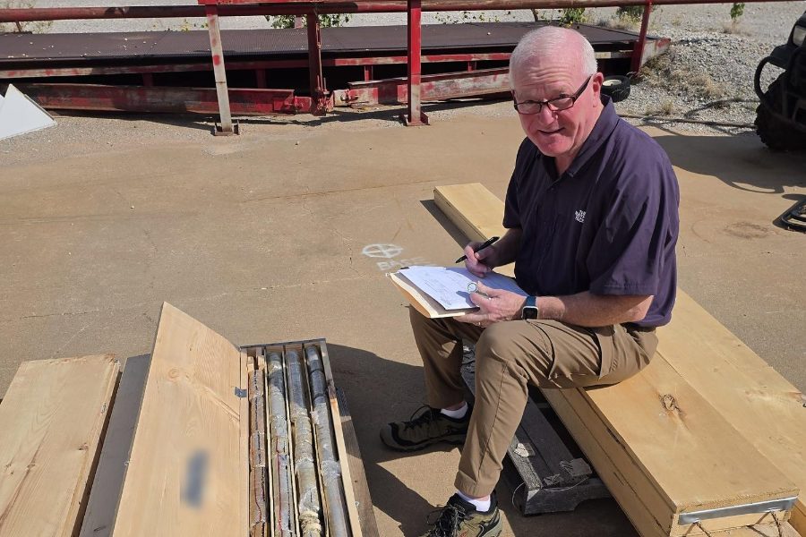 Consulting geologist logging drill core from an exploratory test hole